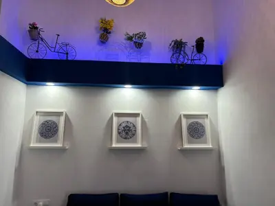 a wall with three plates and a shelf with bikes on it at Studio 1 Port Valencia in Valencia