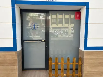 a door to a building with a bench in front of it at Studio 1 Port Valencia in Valencia