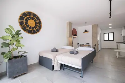 a bedroom with two beds and a potted plant at NEW BEACH Flats valencia 1 in Valencia