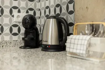 a black and silver tea kettle on a kitchen counter at NEW Beach Flats Valencia 3 in Valencia