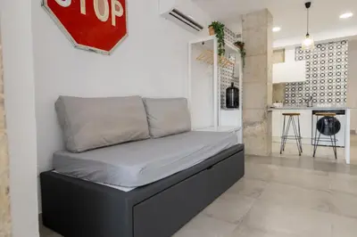 a bed in a room with a stop sign on the wall at NEW Beach Flats Valencia 3 in Valencia