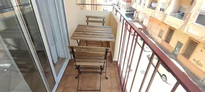 a table and two stools on a balcony at Apartamento 3 Habitaciones 2 Baños in Puerto de Sagunto