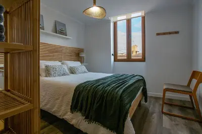 a bedroom with a bed and a window and a chair at Tenerias Apart Corp , 4 Piso in Valencia