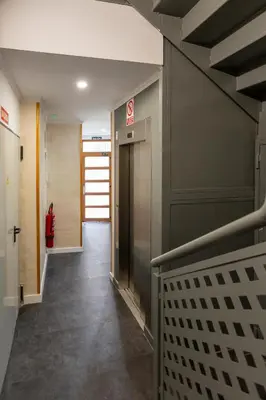 a hallway in a building with a elevator at Tenerias Apart Corp , 4 Piso in Valencia