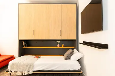 a bedroom with a bed with a wooden cabinet at SingularStays Padre Urbano in Valencia
