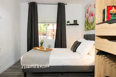 a bedroom with a bed and a window at SingularStays Padre Urbano in Valencia