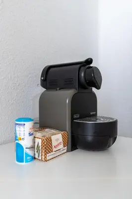 a coffee maker sitting next to a box of food at Habitación Maritim 1 in Valencia