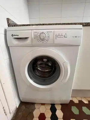 a white washing machine sitting in a kitchen at Habitación Maritim 2 in Valencia