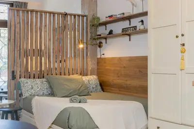 a bedroom with a bed with a wooden headboard at Cozy loft Jubeco in Valencia
