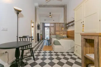 a bedroom with a bed and a checkerboard floor at Cozy loft Jubeco in Valencia