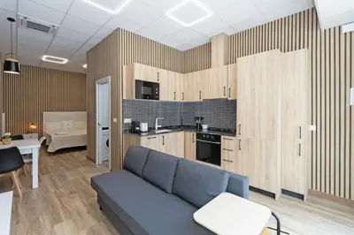 a living room with a blue couch and a kitchen at GuestReady - Delightful Valencian Stay in Valencia
