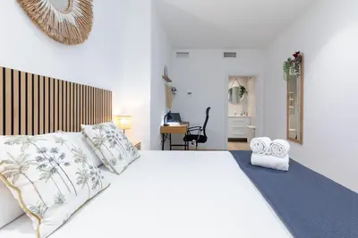 a bedroom with a large white bed with pillows at Travel Habitat Marítim-Serrería Lofts in Valencia