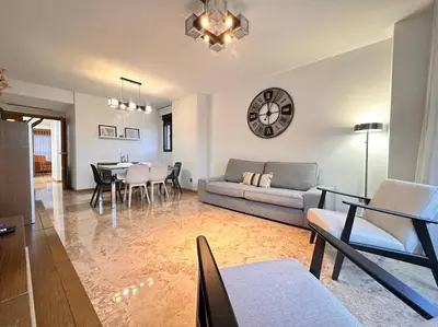 a living room with a couch and a table at Amplio y Lujoso con vistas in Valencia