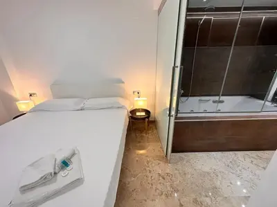 a bedroom with a large bed and a bath tub at Amplio y Lujoso con vistas in Valencia