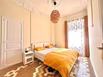 a bedroom with a bed and a large window at Stylish Ruzafa Market in Valencia