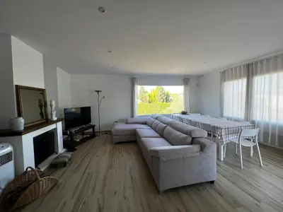 a living room with a large couch and a table at Acogedora casa con piscina in Lliria
