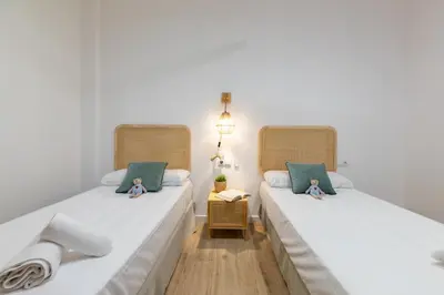 two beds sitting next to each other in a room at Travel Habitat Ruzafa Lofts in Valencia
