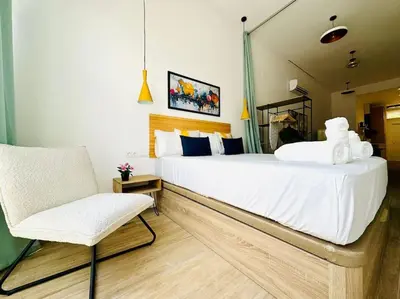 a bedroom with a large white bed and a chair at New Industrial Design Flat in Russafa SOHO in Valencia