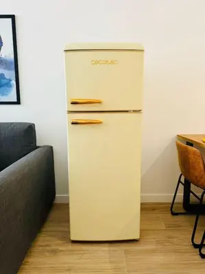 a white refrigerator in a room with a table at New Industrial Design Flat in Russafa SOHO in Valencia