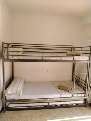 a bunk bed in a room with a bunk bedscribed at Apartamento con parking frente a la playa in Faro de Cullera