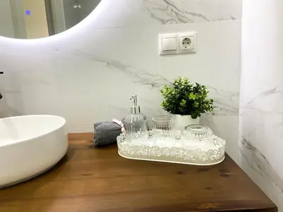 a bathroom with a counter with a sink and a tub at Apartamento Ciencias & Maritim in Valencia