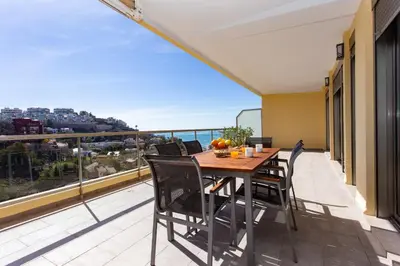 a balcony with a table and chairs and a view at Sea View Terrace Apartment Cullera in Cullera