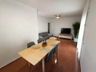 a living room with a table and chairs and a couch at Premium Beach Flat in Las Canteras