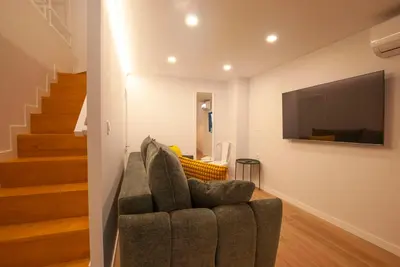 a living room with a couch and a flat screen tv at Quiet Loft in Valencia