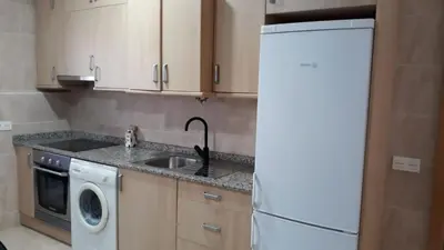 a kitchen with a sink and a white refrigerator at SERRATELLA Puerto in El Puerto