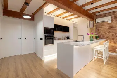 a kitchen with a white island in a room at Your home at Valencia Cabañal 2 in Valencia