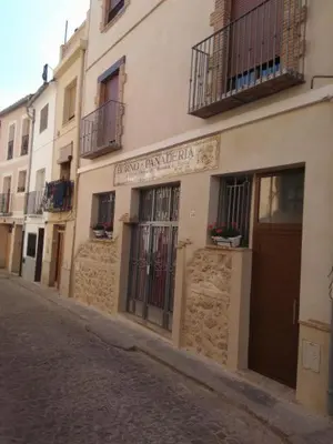 a building with a sign on the side of a street at Alojamientos Segóbriga Rural (Montaña) in Segorbe