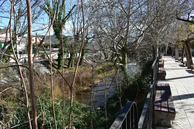 a walkway next to a river with trees at Alojamientos Segóbriga Rural (Montaña) in Segorbe