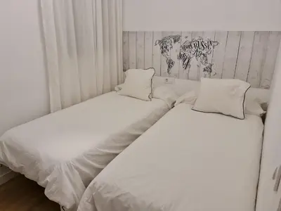 two beds sitting next to each other in a bedroom at Alojamientos Segóbriga Rural (Montaña) in Segorbe