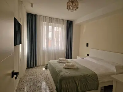 a bedroom with a bed with two towels on it at Relax Degrain in Cullera