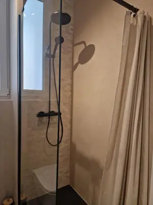 a shower in a bathroom with a shower curtain at Relax Degrain in Cullera