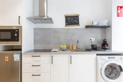 a kitchen with a sink and a washing machine at Nuevo piso cerca de universidad y playa in Valencia