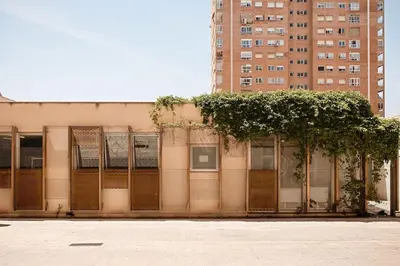 a building with a fence with plants on it at Lofts plaza Orense A New and close to the beach in Valencia