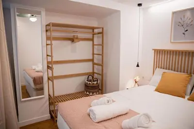 a bedroom with a bed with towels on it at Lofts plaza Orense A New and close to the beach in Valencia
