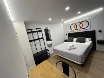 a bedroom with a bed and a chair in it at LOFT Accommodative A in Valencia