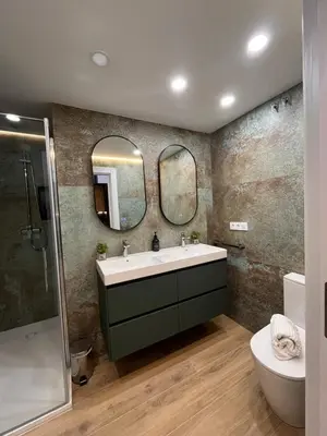 a bathroom with a sink and two mirrors at LOFT Accommodative A in Valencia