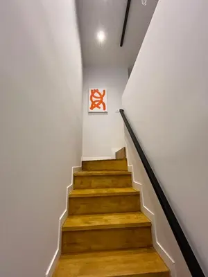 a staircase with white walls and wooden floors at LOFT Accommodative A in Valencia