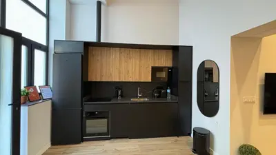 a kitchen with black cabinets and a sink at LOFT Accommodative A in Valencia