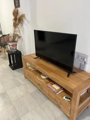 a flat screen tv sitting on top of a wooden entertainment center at Mediterranéo in Valencia