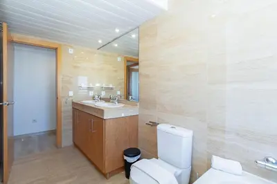 a bathroom with a toilet and a sink at GuestReady - Lovely flat with views in Valencia in Valencia