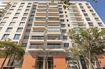 a tall white building with trees in front of it at GuestReady - Lovely flat with views in Valencia in Valencia