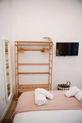 a bedroom with a bed with two pillows and a tv at Lofts Orense E Moderno y cercano a la playa in Valencia