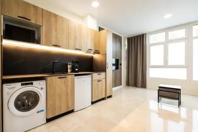 a laundry room with a washer and dryer at Vera Suites by Concept Flats in Valencia