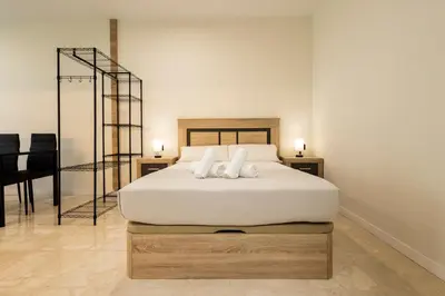 a bedroom with a white bed with two pillows at Vera Suites by Concept Flats in Valencia