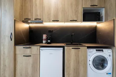 a kitchen with a washing machine and a washer at Vera Garden by Concept Flats in Valencia
