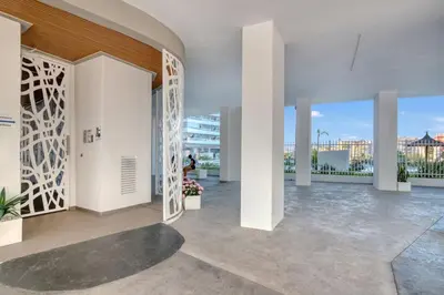 a lobby with white walls and large windows at Luxury Penthouse with Panoramic Sea Views in Canet de Berenguer
